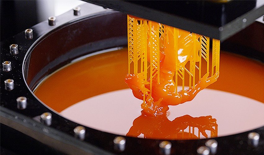 SLA 3D Printer dipping part into resin liquid.