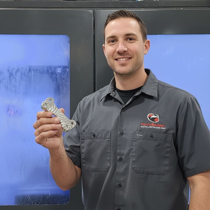 cnc machinist holding custom cnc machined part